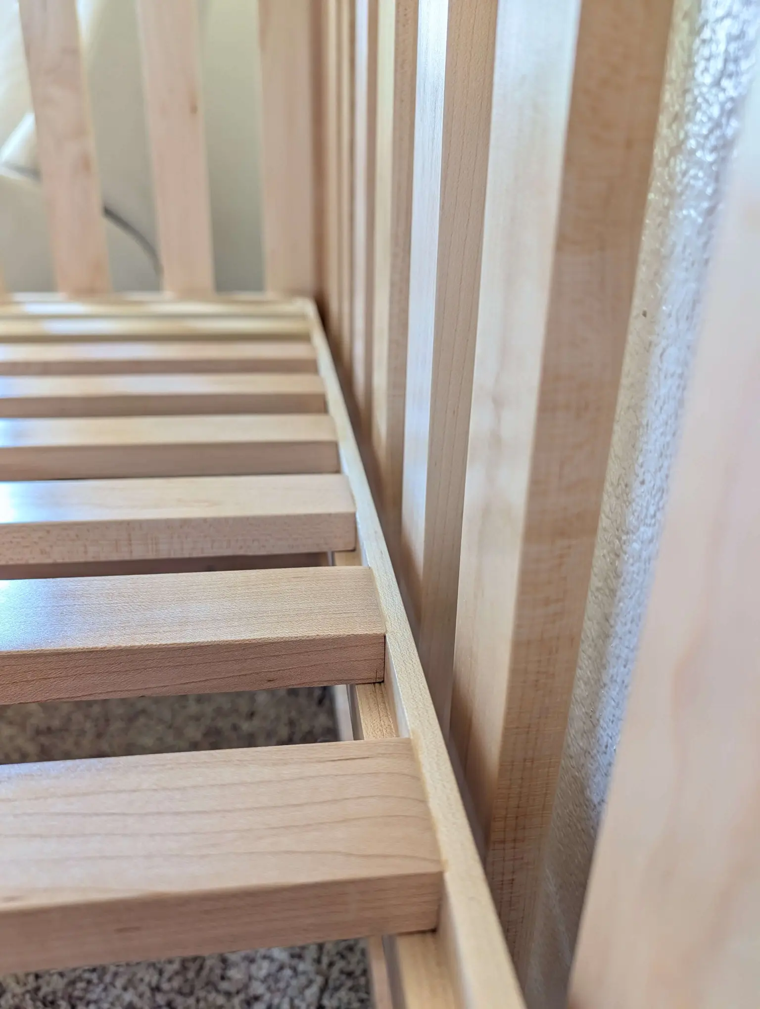 Hard maple crib showing sturdy mattress support