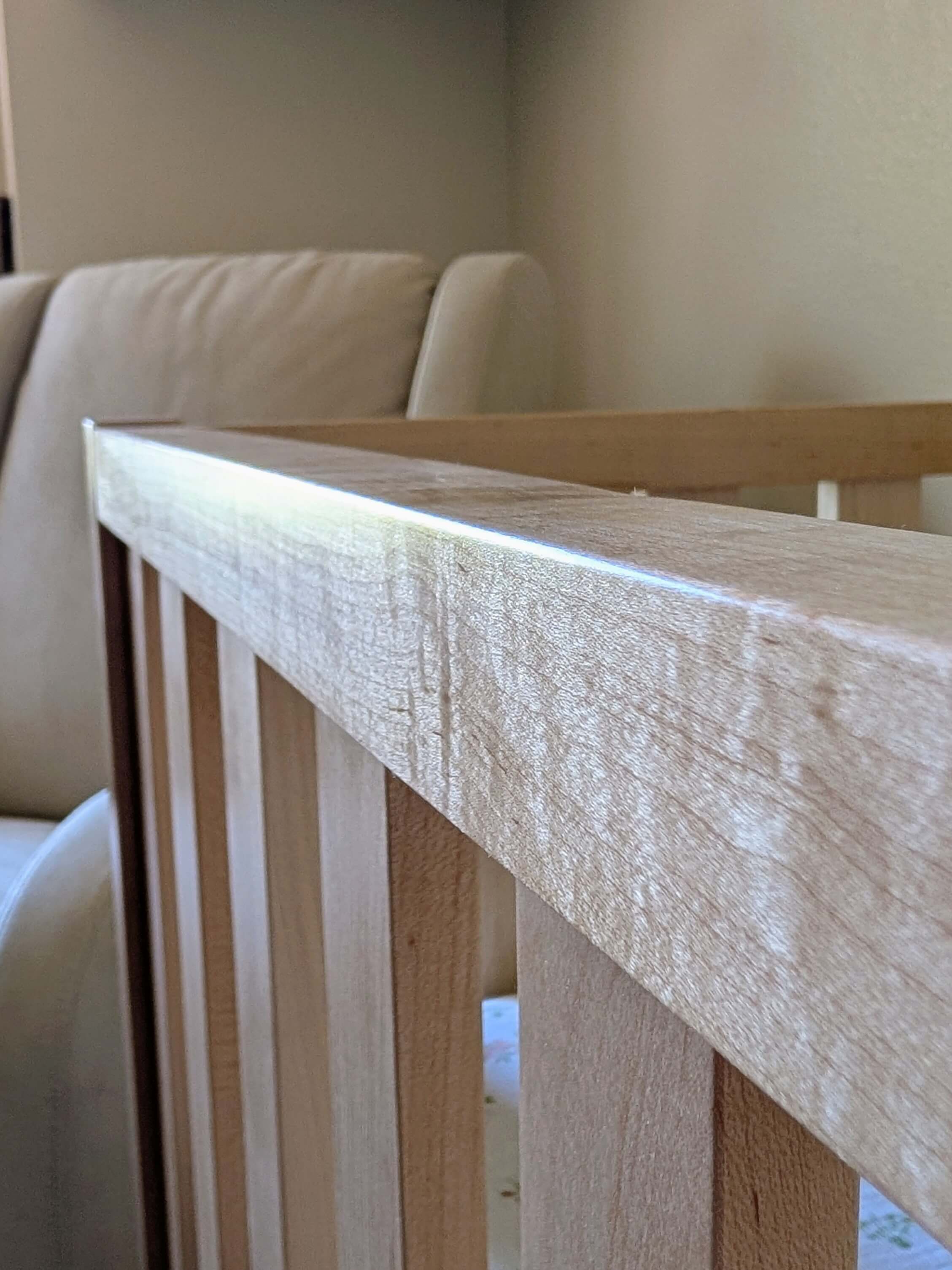 Handcrafted wood crib safety rail assembly